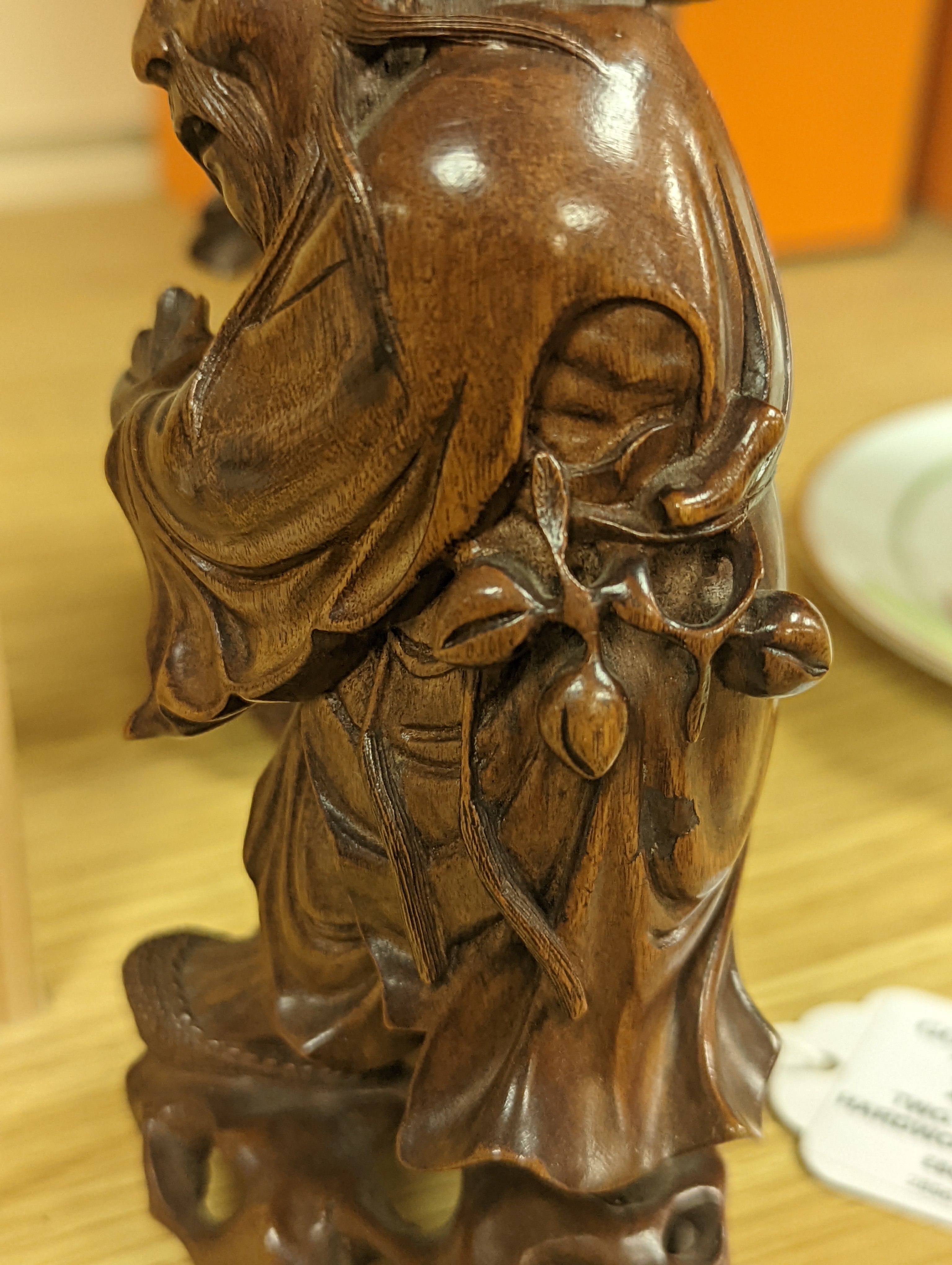 Two Chinese hardwood figures of a fisherman and a old man holding peaches 16cm